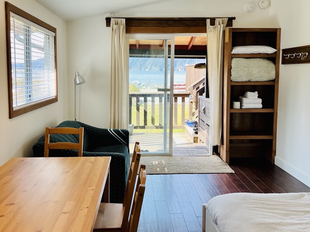 Captains quarters with bed, table, view of ocean. Located in Big Fish Lodge, Port Renfrew, British Columbia