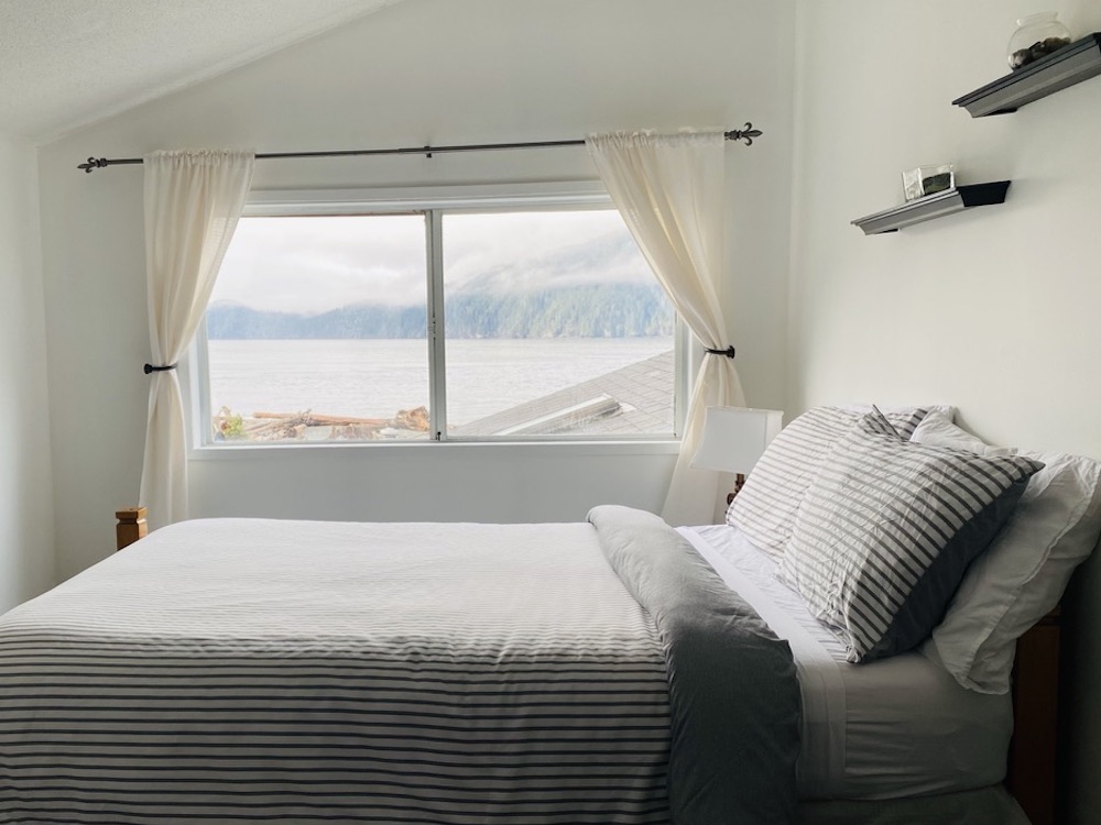 Oceanview room with comfortable bed and view of ocean, in Big Fish Lodge located in Port Renfrew, British Columbia